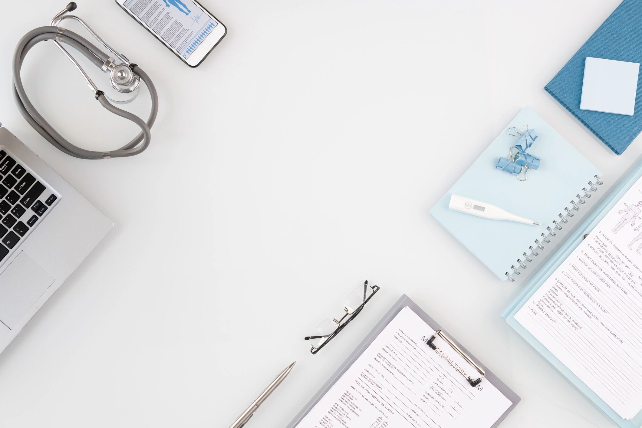 Clinician workspace with documents and medical supplies